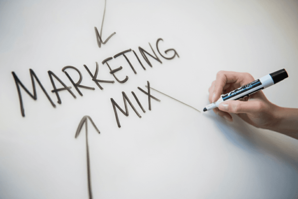 The words "Marketing Mix" written on a whiteboard with arrows pointing towards the words